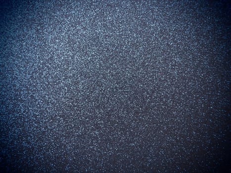 Deep blue shiny bokeh abstract background. Blue - black paper with sparkles. Festive backdrop with dark vignette.