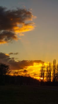 Setting sun on the outskirts of Berlin. The sky seems to burn. Romantic evening sky.