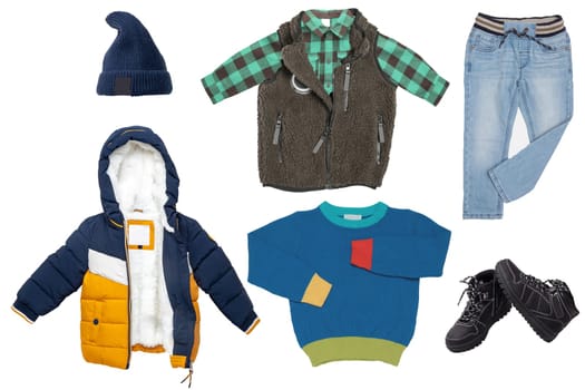 Collage set kids winter clothing isolated on a white background. Denim trouser or jeans, boots, a down jacket, vest with shirt, cap and pullover or sweater shirt for child boy. Children autumn fashion.