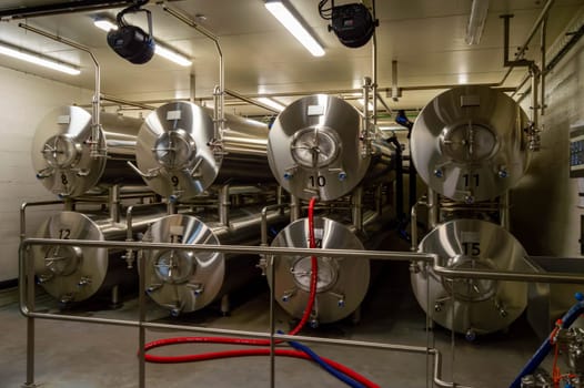 Modern interior of a brewery containing stainless steel mash vats in the ardennes in Belgium