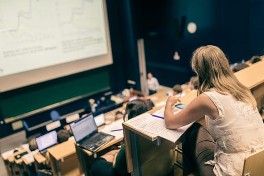 Conference and Presentation. Audience at the conference hall. Business and Entrepreneurship. Faculty lecture and workshop. Audience in the lecture hall. Academic education. Student making notes.