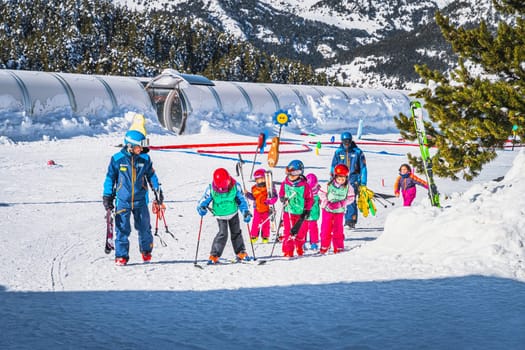 El Tarter, Andorra, Jan 2020 Ski instructors teaching a group of young kids how to ski. Winter holidays in Pyrenees Mountains