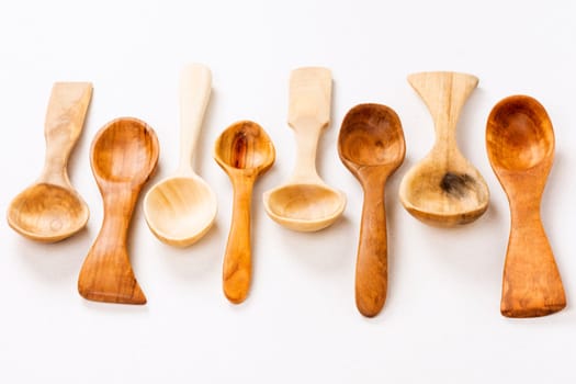 Wooden spoons are on white background, wood carving concept.