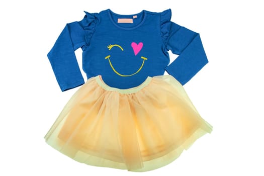 Children clothes. Fashionable festive yellow short summer skirt and a long sleeved blue shirt for the little girl isolated on white. Clipping path. Ballerina kids clothing.