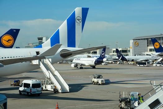 Frankfurt Airport Germany August 02, 2022 - Airplanes and some luggage trolleys at the terminal
