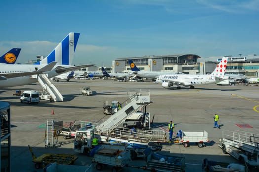 Frankfurt Airport Germany August 02, 2022 - Airplanes and some luggage trolleys at the terminal