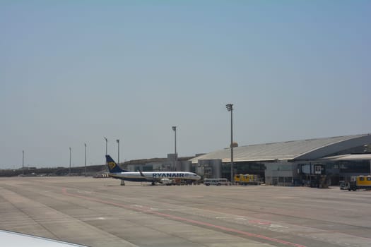 Tenerife South Airport Spain August 02, 2022 - Reina Sofía Airport terminal from the outside with Ryanair plane
