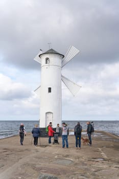 Holidaymakers at the Muhlenbake, the landmark of Swinoujscie on the Polish Baltic coast