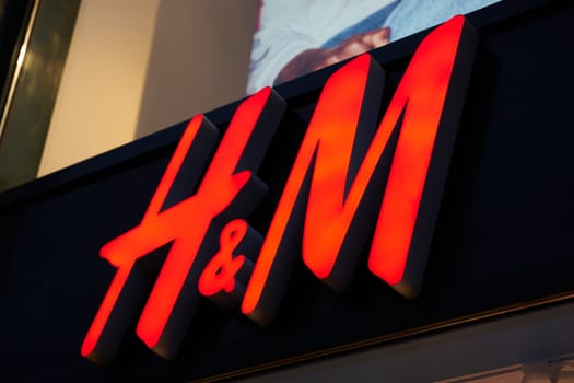 Illuminated advertisement of the Swedish textile retailer H&M, Hennes & Mauritz, in a shopping street in Berlin