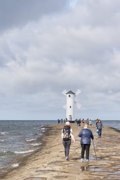 Holidaymakers at the Muhlenbake, the landmark of Swinoujscie on the Polish Baltic coast
