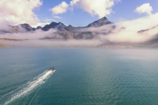 A tourist Zodiac enters the foggy bay of the now abandoned whaling station at Grytviken - on the island of South Georgia.