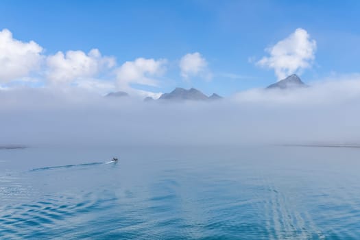 A tourist Zodiac enters the foggy bay of the now abandoned whaling station at Grytviken - on the island of South Georgia.