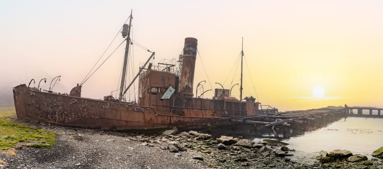 Old, rusty whaling ships and processing facilities at a now abandoned whaling station in Grytviken -on the island of South Georgia.