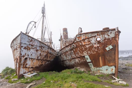 Old, rusty whaling ships and processing facilities at a now abandoned whaling station in Grytviken -on the island of South Georgia.