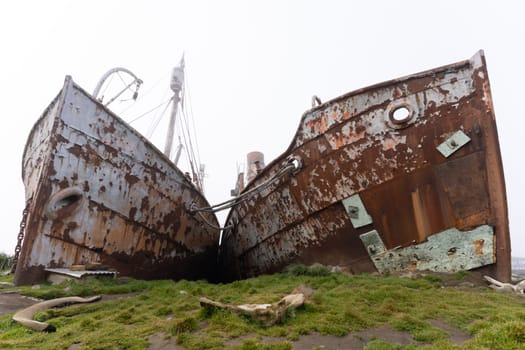 Old, rusty whaling ships and processing facilities at a now abandoned whaling station in Grytviken -on the island of South Georgia.