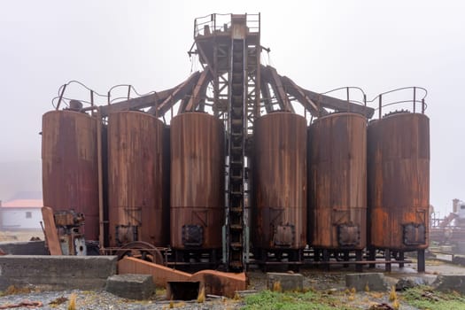 Old, rusty whaling ships and processing facilities at a now abandoned whaling station in Grytviken -on the island of South Georgia.