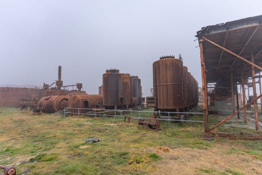 Old, rusty whale oil tanks and processing facilities at a now abandoned whaling station in Grytviken -on the island of South Georgia.