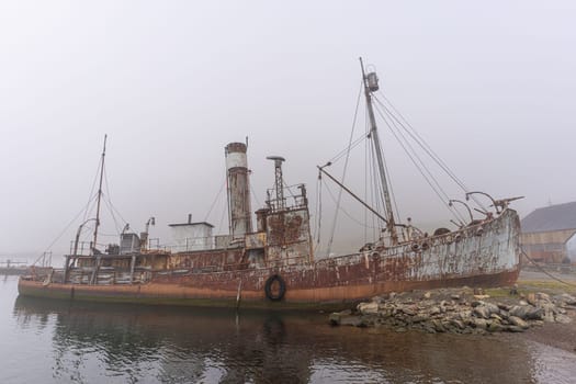 Old, rusty whaling ships and processing facilities at a now abandoned whaling station in Grytviken -on the island of South Georgia.