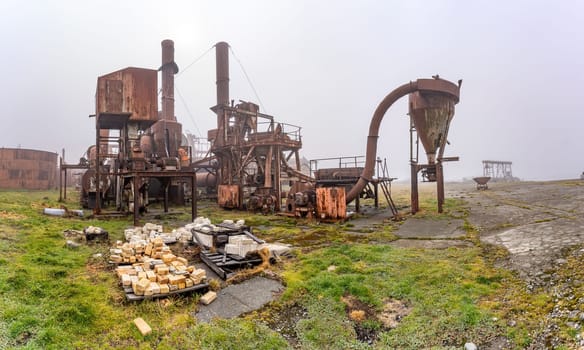 Old, rusty whale oil tanks and processing facilities at a now abandoned whaling station in Grytviken -on the island of South Georgia.