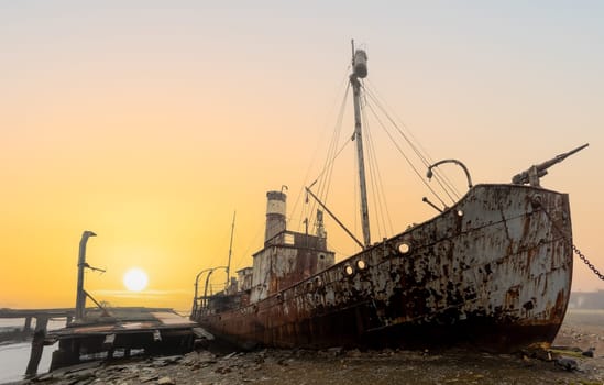 Old, rusty whaling ships and processing facilities at a now abandoned whaling station in Grytviken -on the island of South Georgia.
