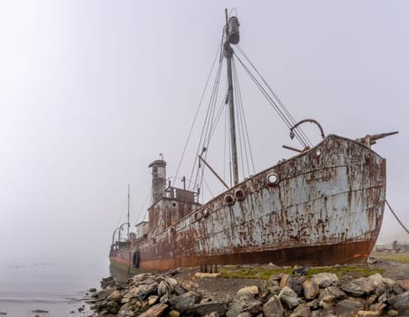 Old, rusty whaling ships and processing facilities at a now abandoned whaling station in Grytviken -on the island of South Georgia.