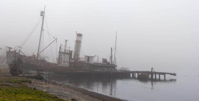 Old, rusty whaling ships and processing facilities at a now abandoned whaling station in Grytviken -on the island of South Georgia.