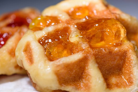 Close up of fresh waffles topped with delicious sweet pineapple jam on top. Making homemade food or dessert at home