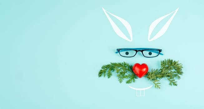 Easter rabbit face with a heart shaped nose, whiskers from carrot leaves and eyeglasse, holiday greeting card, spring season