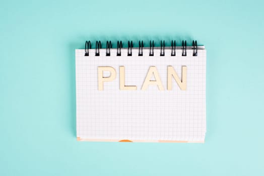 Plan is standing in a notebook, planning new goals, to do list, new year resolutions
