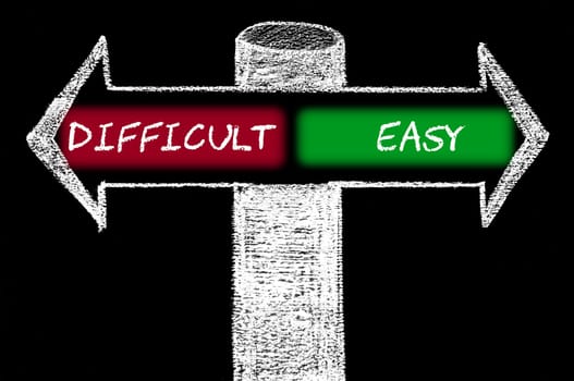 Opposite arrows with Difficult versus Easy. Hand drawing with chalk on blackboard. Choice conceptual image