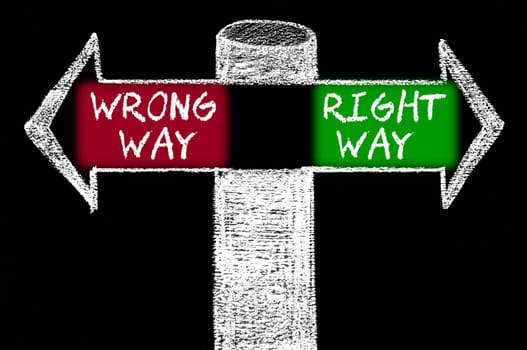 Opposite arrows with Wrong Way versus Right Way. Hand drawing with chalk on blackboard. Choice conceptual image