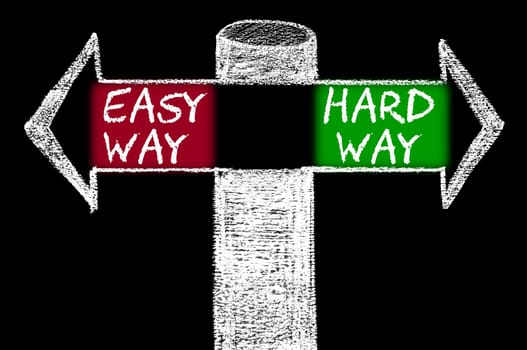 Opposite arrows with Easy Way versus Hard Way. Hand drawing with chalk on blackboard. Choice conceptual image