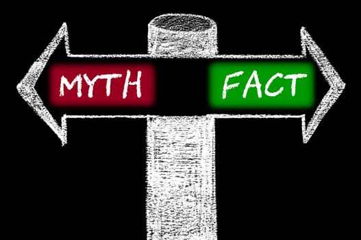 Opposite arrows with Myth versus Fact. Hand drawing with chalk on blackboard. Choice conceptual image