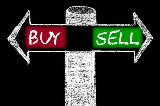 Opposite arrows with Buy versus Sell. Hand drawing with chalk on blackboard. Choice conceptual image