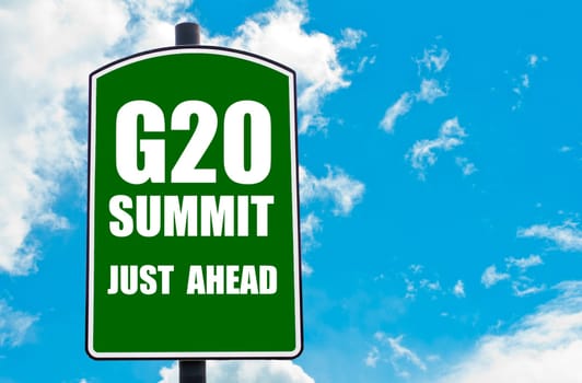 G20 SUMMIT Just Ahead written on green road sign  against clear blue sky background. Concept image with available copy space