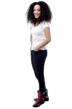 Full length of trendy woman with hands in pockets