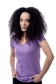 Smiling young woman with hands in pockets