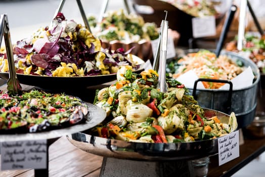 Salads displayed on buffet in individual containers