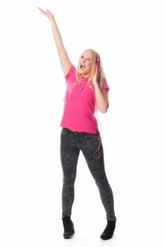 Young woman with headphones listens to music and sings along
