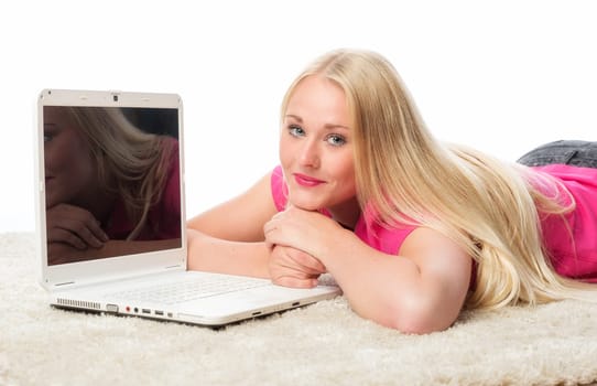 Blonde lies on the floor with laptop