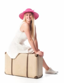 Girl sits on a suitcase and waits