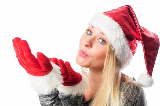 Girl with Christmas hat puffs over her hands