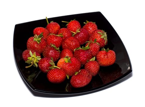 strawberry on a black plate a side view, the isolated image