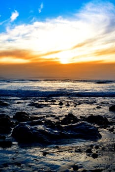 reflections at rocky beal beach near ballybunion on the wild atlantic way ireland with a beautiful yellow sunset