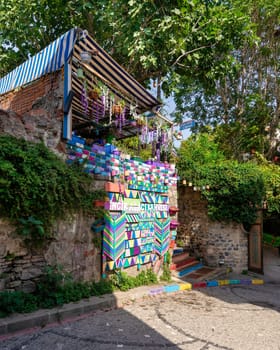 Exterior daytime shot of cafe decorated with multicolored panels colorful stairs, and canopy in Balat District, Istanbul, Turkey