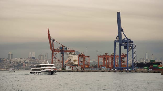 Istanbul, Turkey - August 25, 2022: Day shot of the cranes in the shipyard of the Port of Haydarpasha, Istanbul, Turkey with city view in the background
