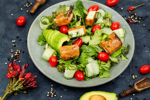 Tasty salad of greens, cucumber, avocado, tomatoes and grilled tofu soy cheese. Healthy Vegetarian Meals