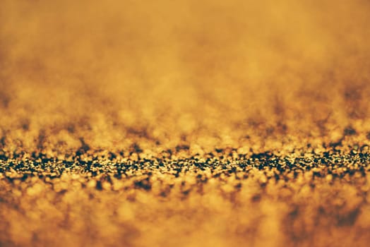 Blur neon gold light circle background. Sparkling firework bokeh dots in retro film filter style. Luxury and classy new year and christmas celebration party textured backdrop. Blurry golden dust particles.
