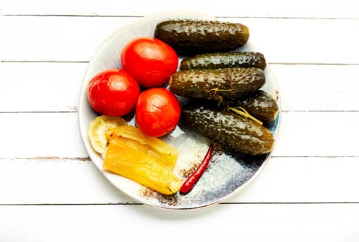 Assorted vegetable pickles, spicy pickled on a plate. Marinated vegetables