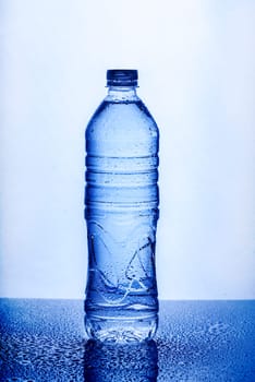 Fresh drinking mineral water in plastic bottle on white background. Healthy living concept.